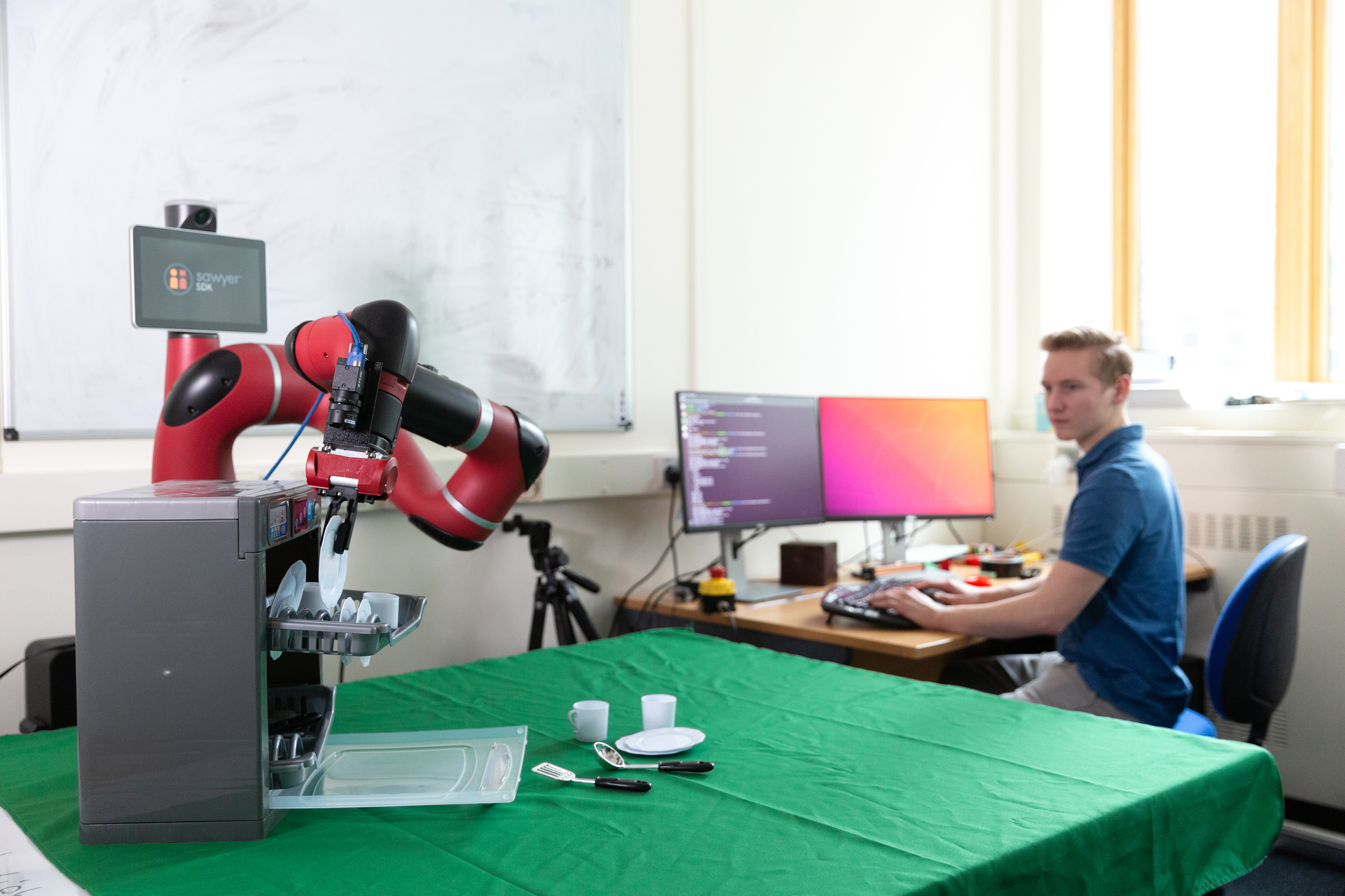Kamil Dreczkowski teaching a robot how to iron a shirt.
