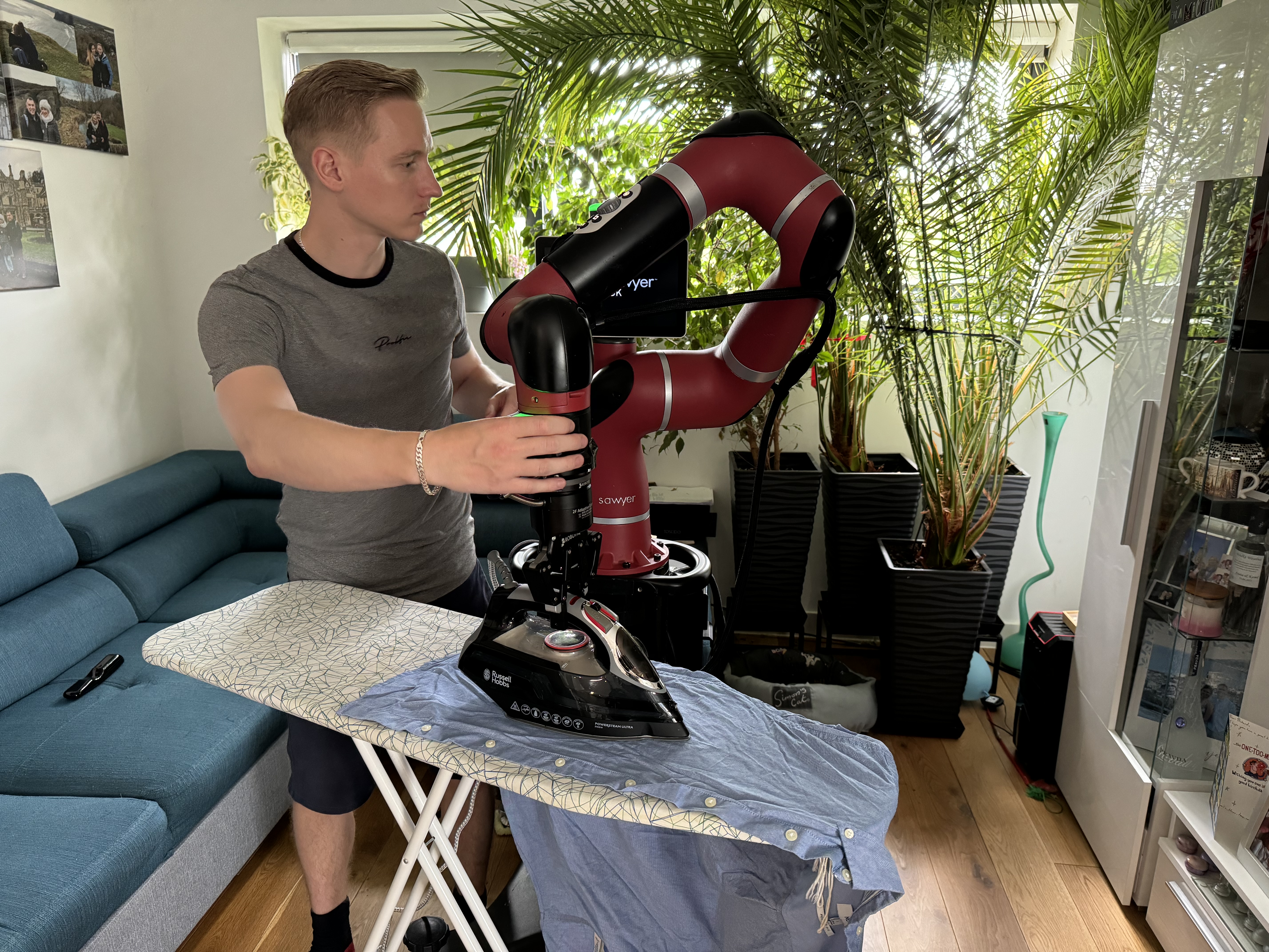 Kamil Dreczkowski teaching a robot how to iron a shirt.